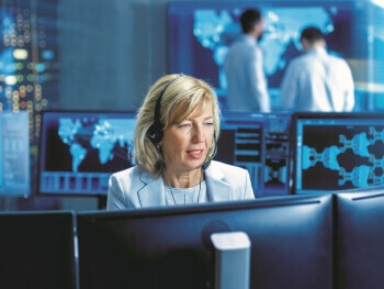 Women with a headset working on a computer