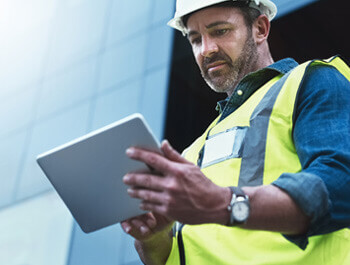 Technician analyzing energy stats on a tablet